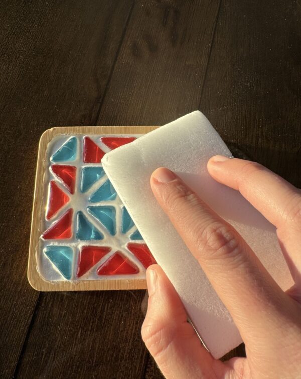 Mosaic art kit sponge cleaning grout off of tiles